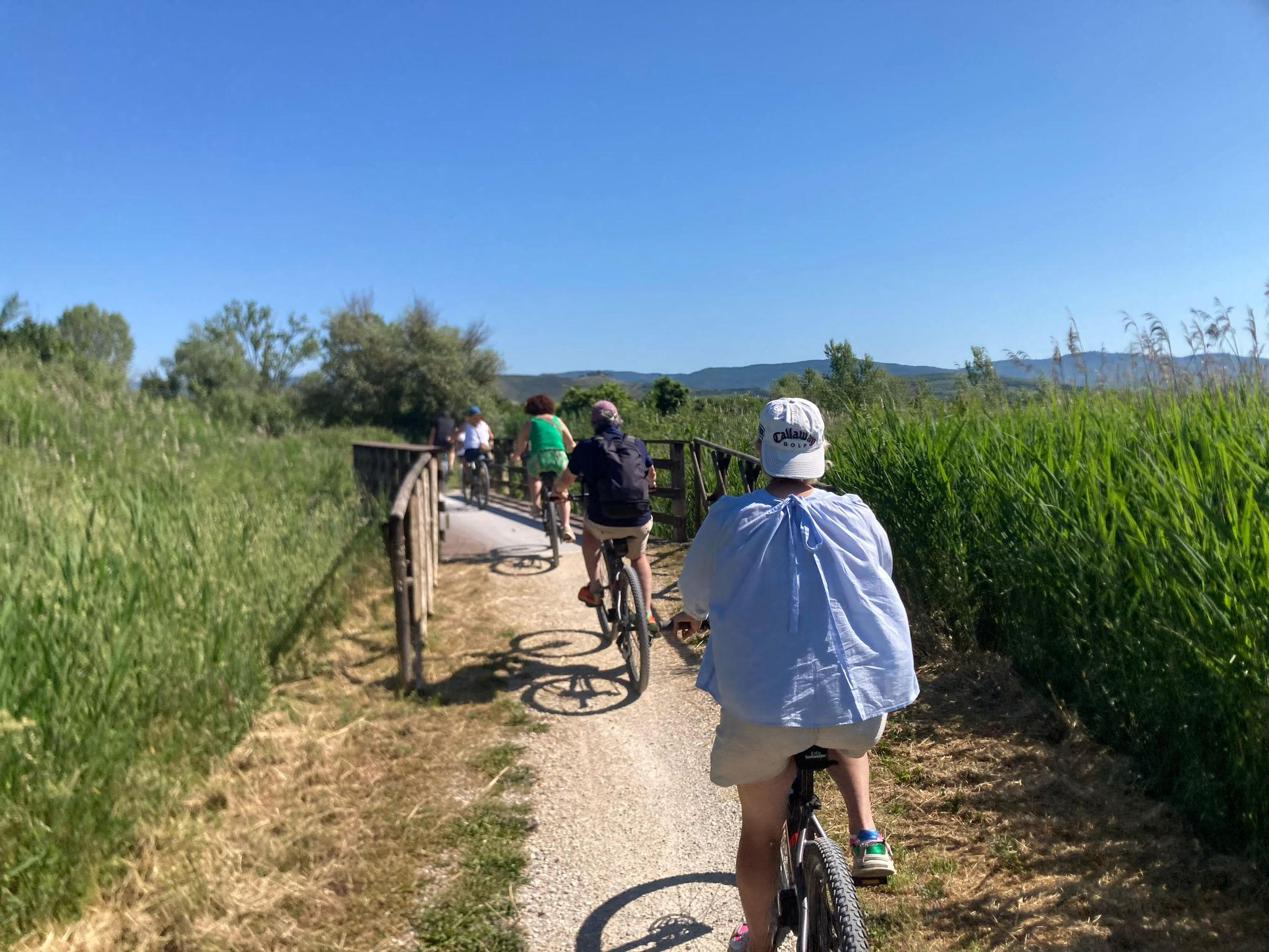 A bike resting by the shore of Lake Trasimeno on a sunny day